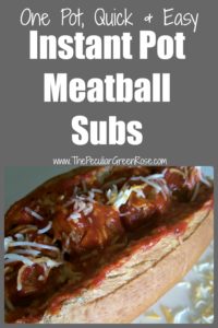 A white plate with a sub bread filled with meatballs in marinara sauce and sprinkled with cheese.