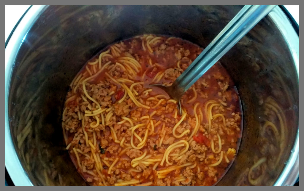 An Instant Pot filled with cooked Spaghetti.