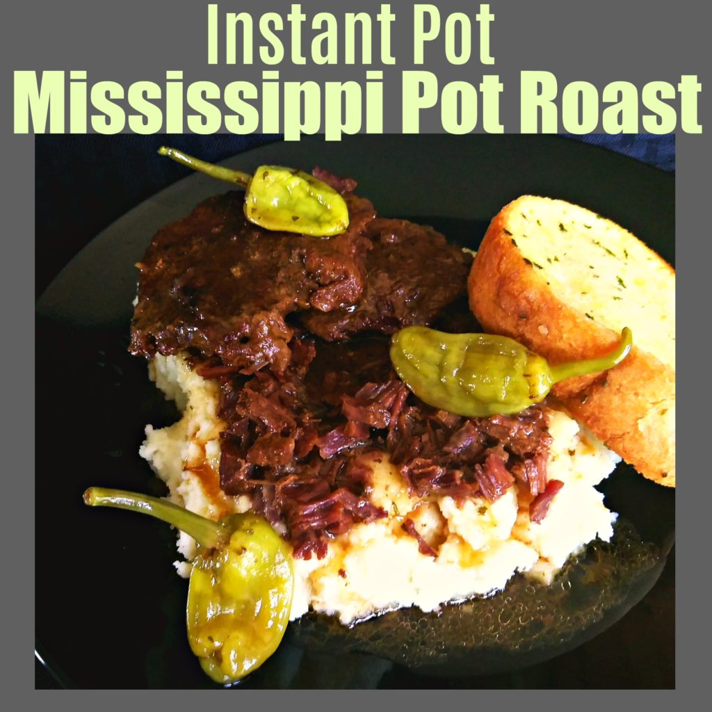 A plate of mashed potatoes topped with Mississippi Pot Roast, gravy, and peperoncini peppers. Also a garlic bread. | Mississippi Pot Roast Instant Pot