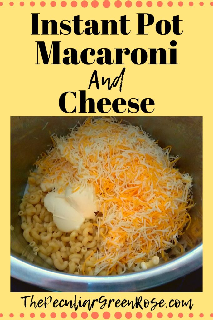A Instant Pot filled with cooked elbow noodles and unmixed butter and shredded cheese.