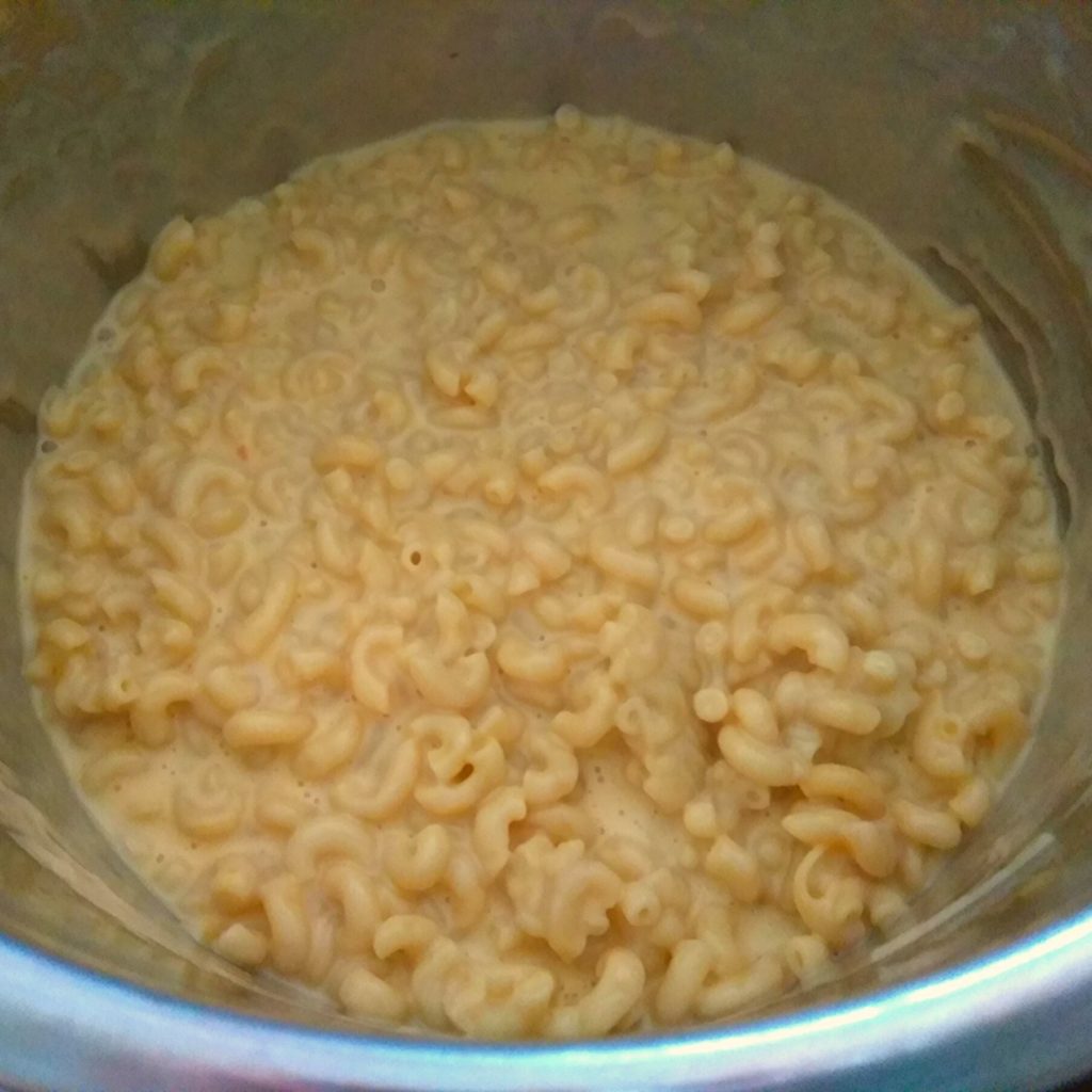 An Instant Pot filled with cooked macaroni and cheese.