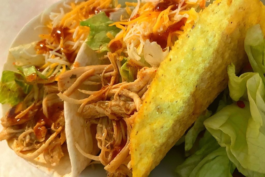 A hard corn tortilla shell and white flour soft shell Shredded Ranch Chicken Tacos.