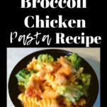 A black bowl filled with broccoli chicken pasta.