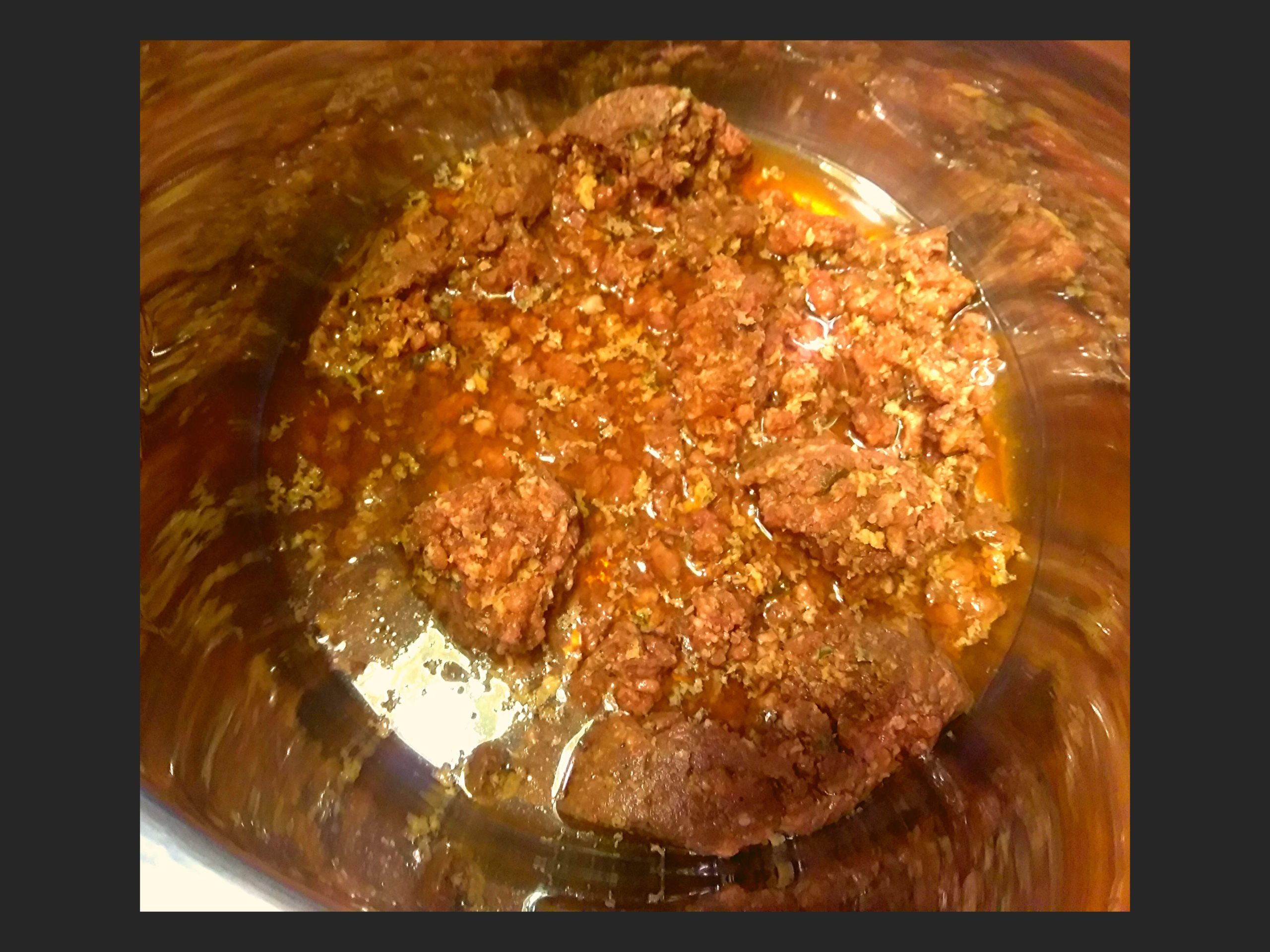 The inside of an Instant Pot with Savoies Cajun Rice Dressing Mix stirred up