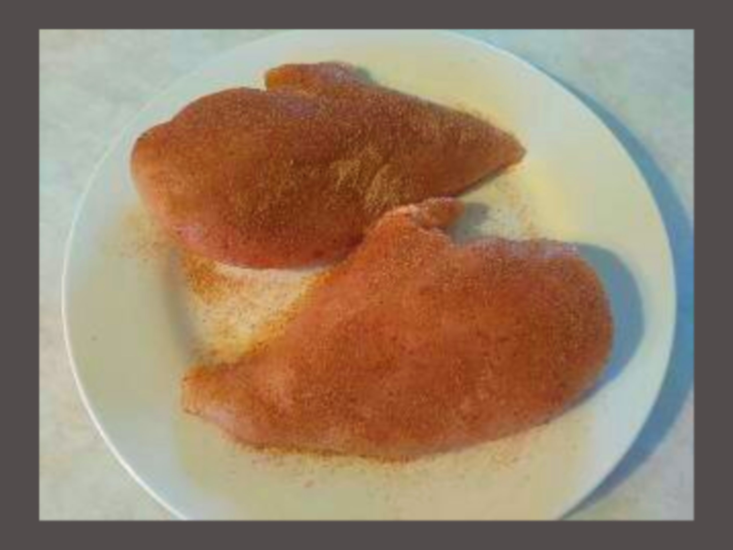 2 Raw Chicken Breasts with Tony Chachere's and Nature Seasoning.