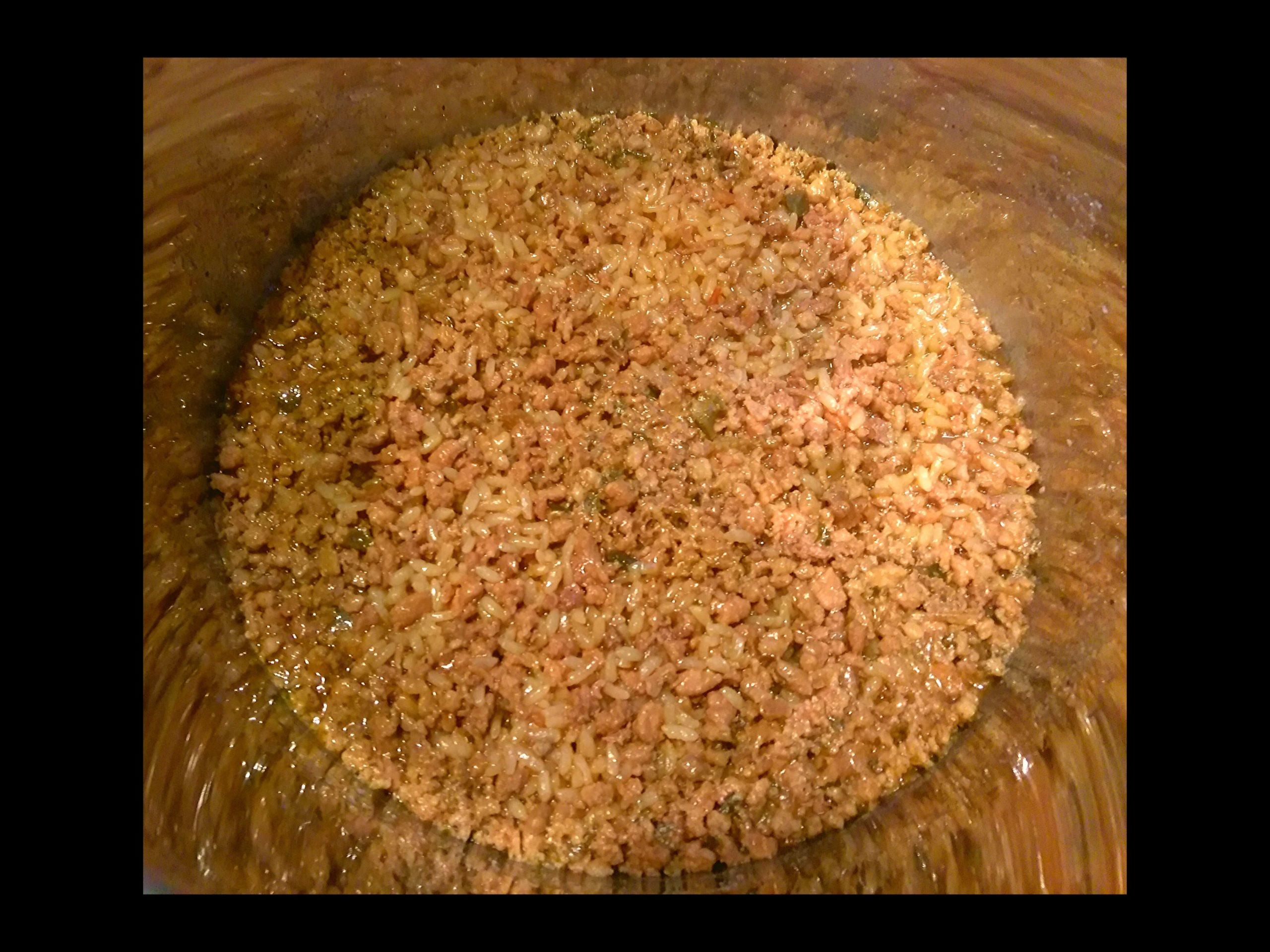 The inside of an Instant Pot with cooked Cajun Rice Dressing.