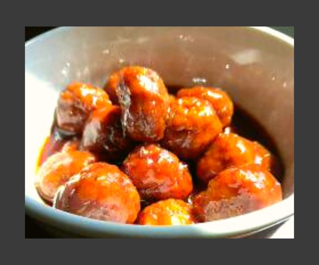 A white bowl filled with bbq meatballs.