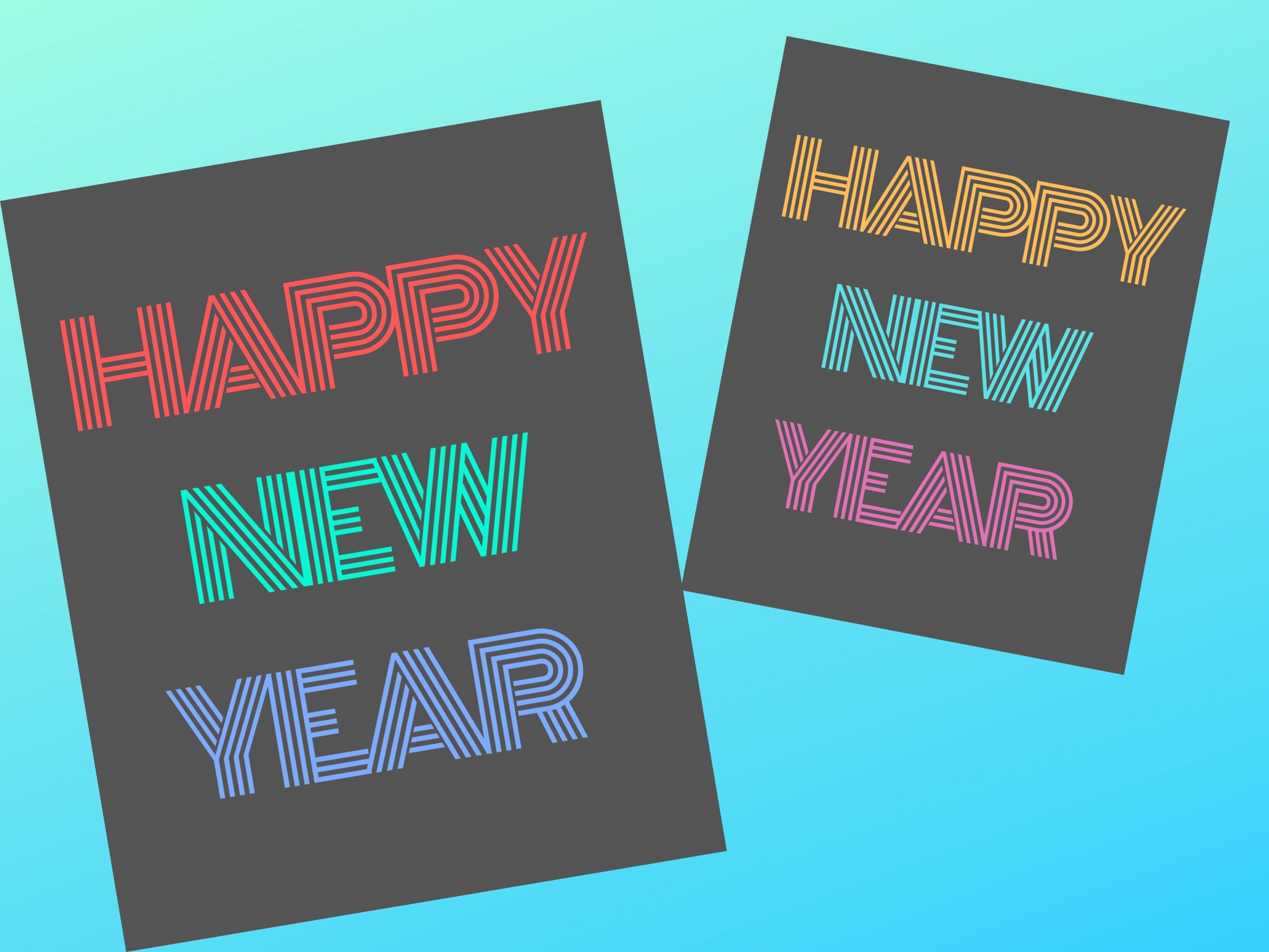 Two grey 8" x 10" decorations with pink, green, blue, and yellow lettering saying "Happy New Year".