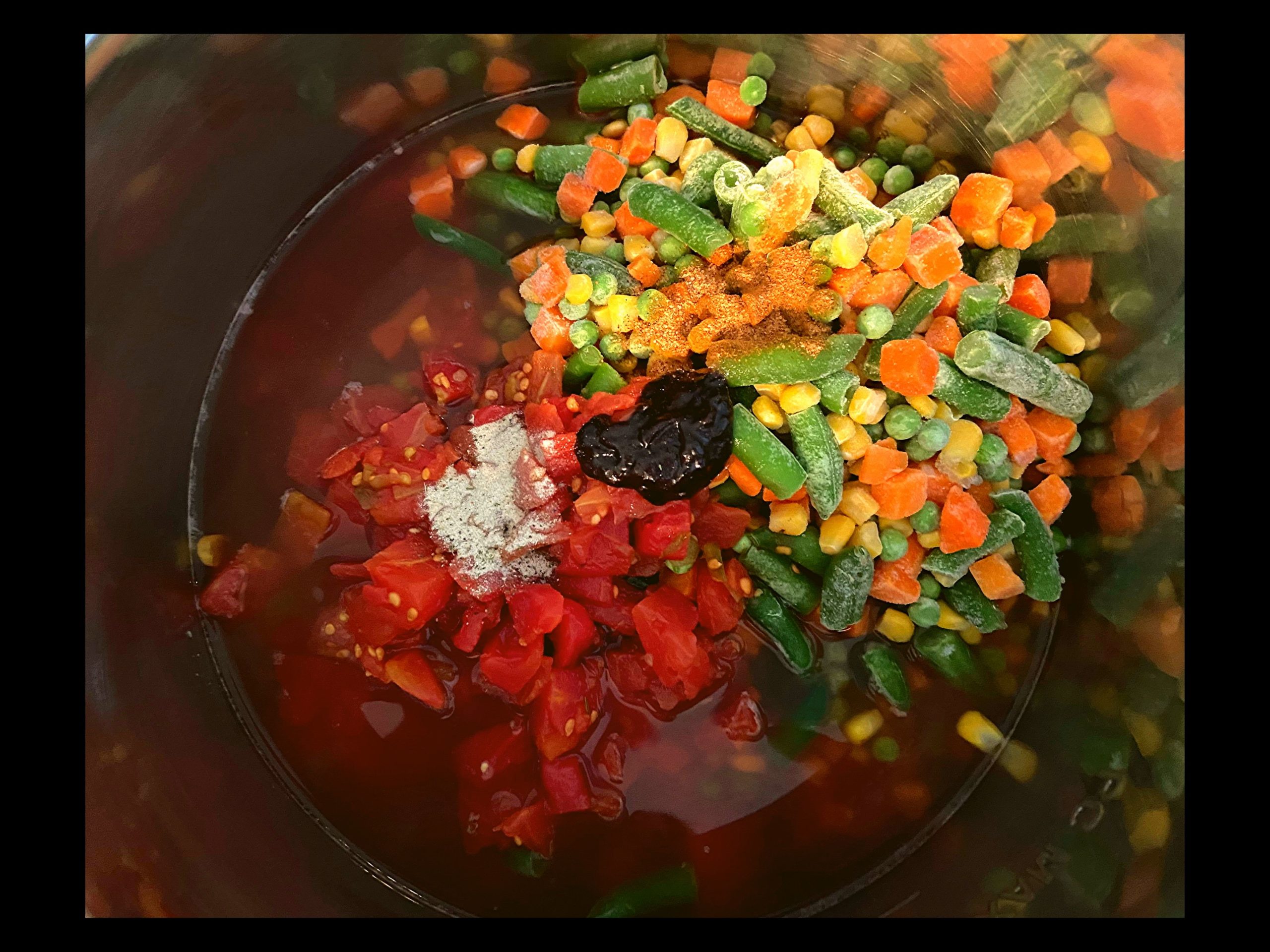 Rotel tomatoes, raw stew meat, beef broth, frozen mixed vegetables, seasoning, and better than beef bouillon dumped into and Instant pot.