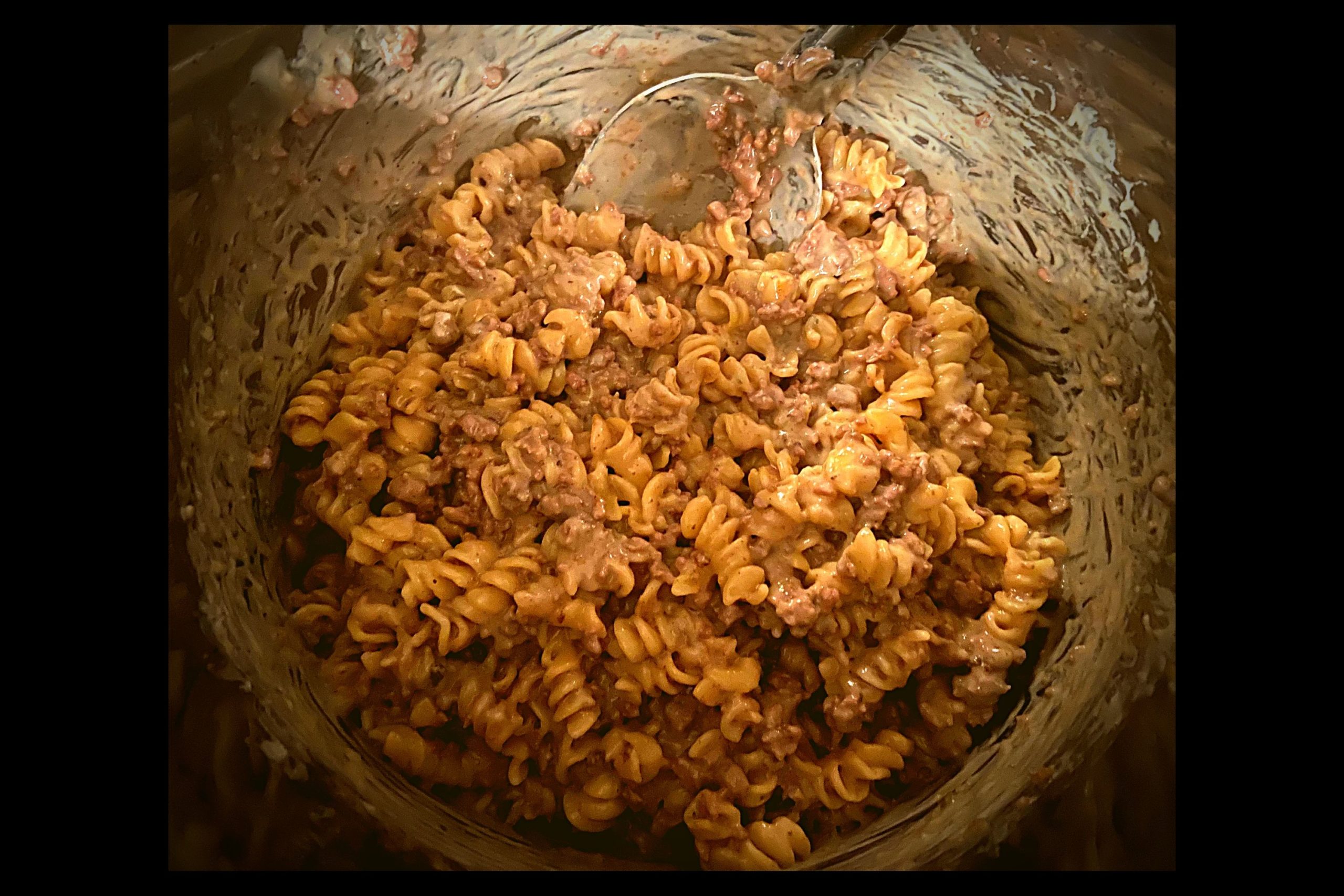 The inside of a silver Instant Pot filled with ground beef stroganoff.