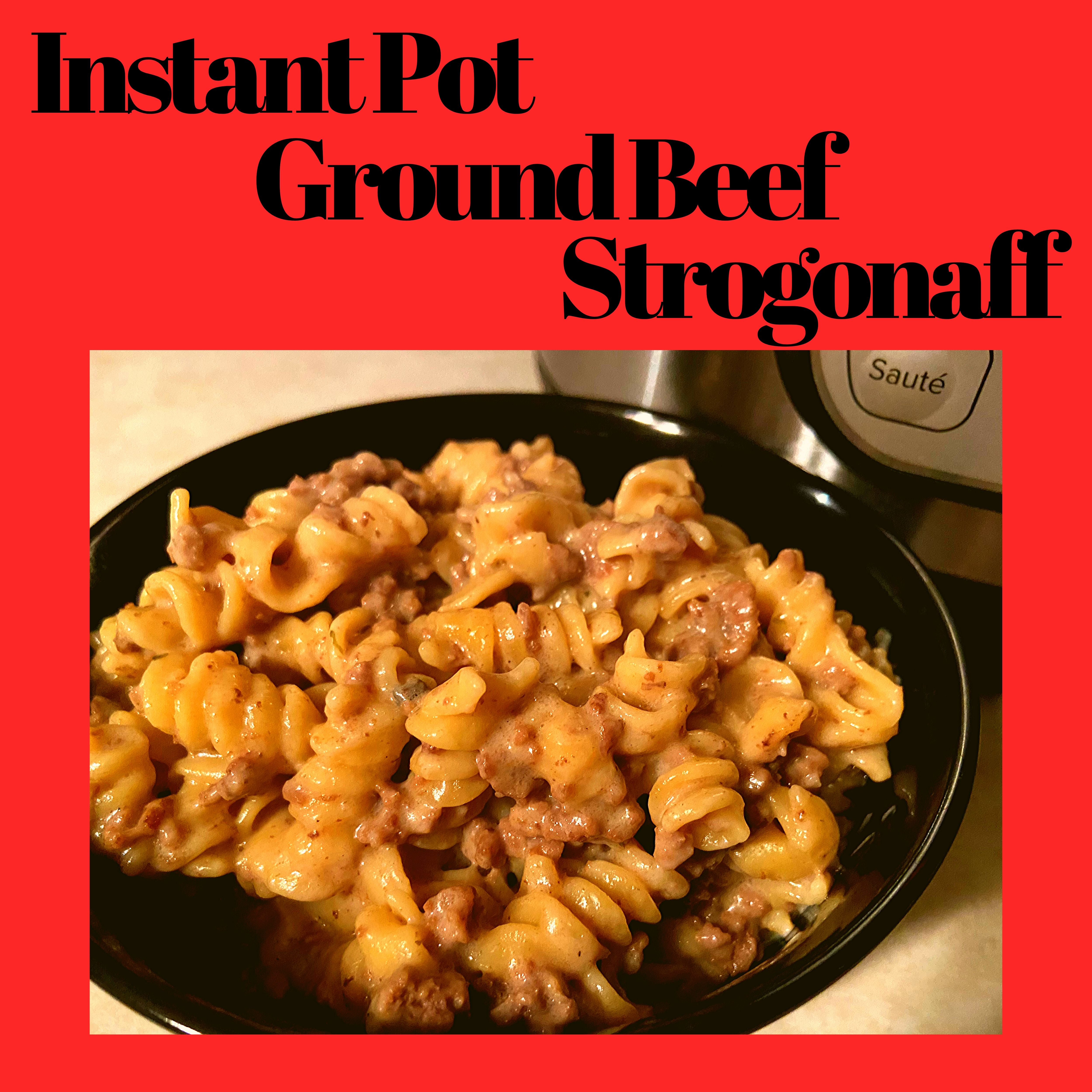 A black bowl filled with ground beef stroganoff sitting on a kitchen counter in front of an Instant Pot.