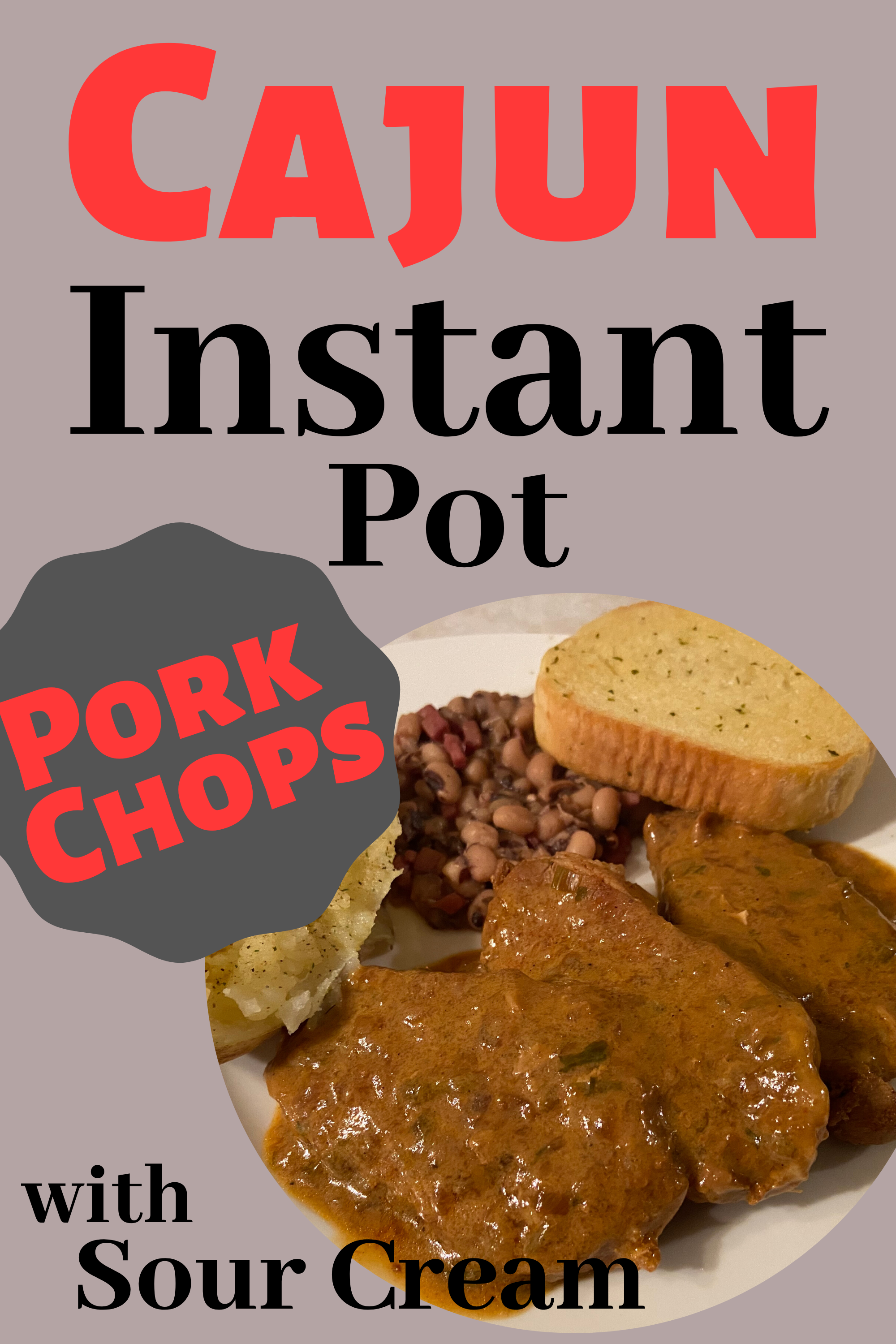 A white plate with boneless pork chops covered in gravy with a baked potato, black eyed peas, and a garlic bread.