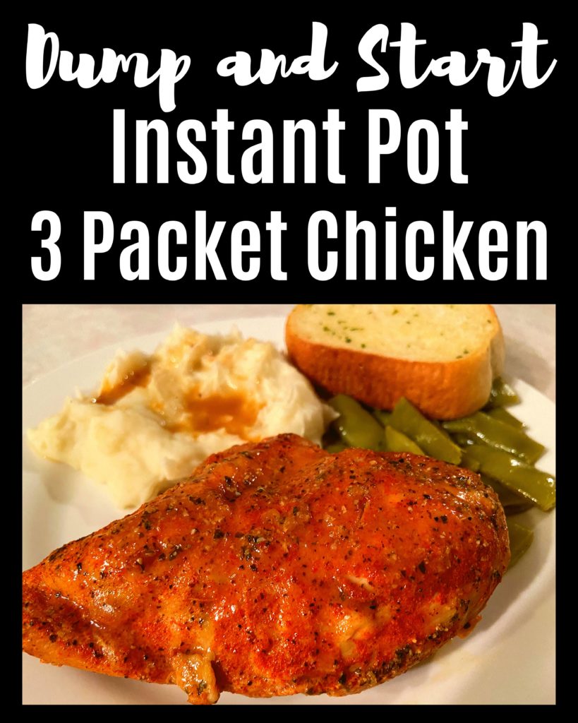 A white plate with a cooked 2 packet chicken breast, green beans, and mashed potatoes with gravy sitting on a kitchen counter top.