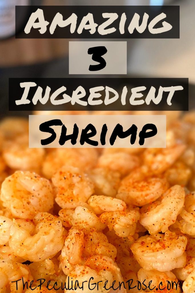 A black plate full of shrimp covered in a butter and cajun seasoning sauce sitting in front of an Instant Pot.