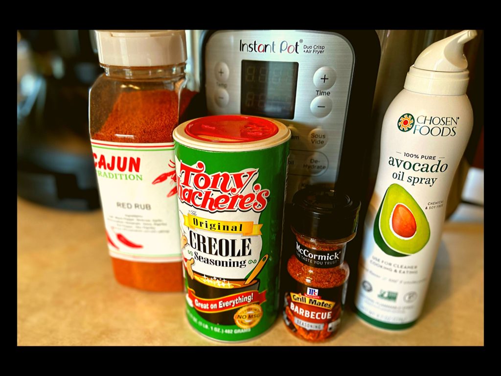 An Instant Pot, Cajun Tradition Red Rub Seasoning, Tony Chachere's Seasoning, McCormick BBQ Seasoning, and Avocado Oil Spray