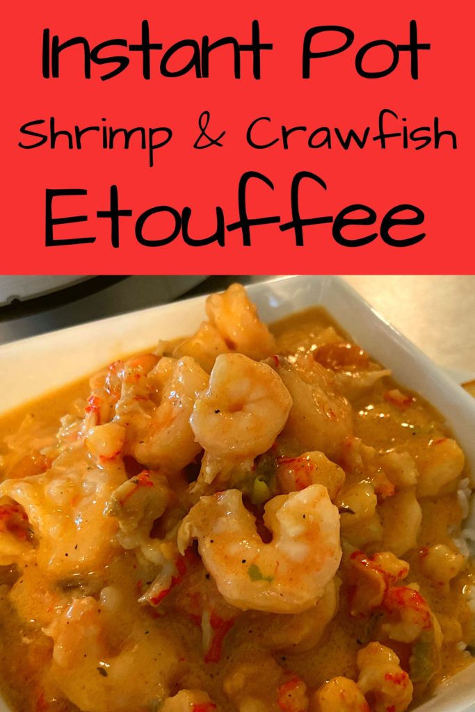 Shrimp and crawfish etouffee over rice in a white bowl.