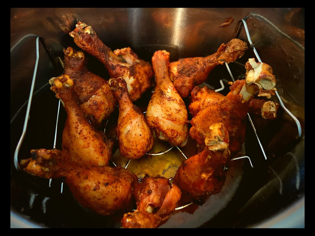 The inside of an Instant Pot filled with cooked BBQ Chicken Drumsticks