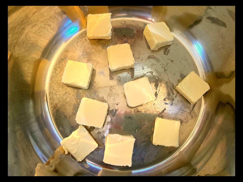 The inside of an Instant Pot with a sliced stick of butter on the bottom