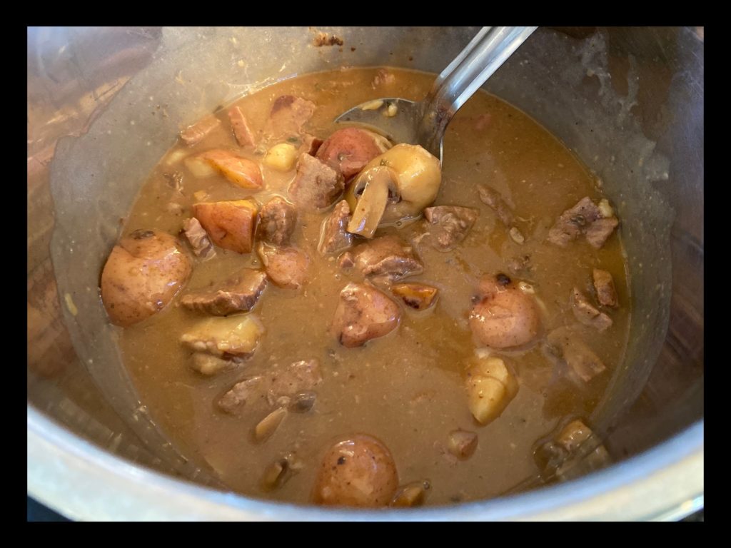 The inside of an Instant Pot with cooked Beef Tips and Gravy with potatoes.