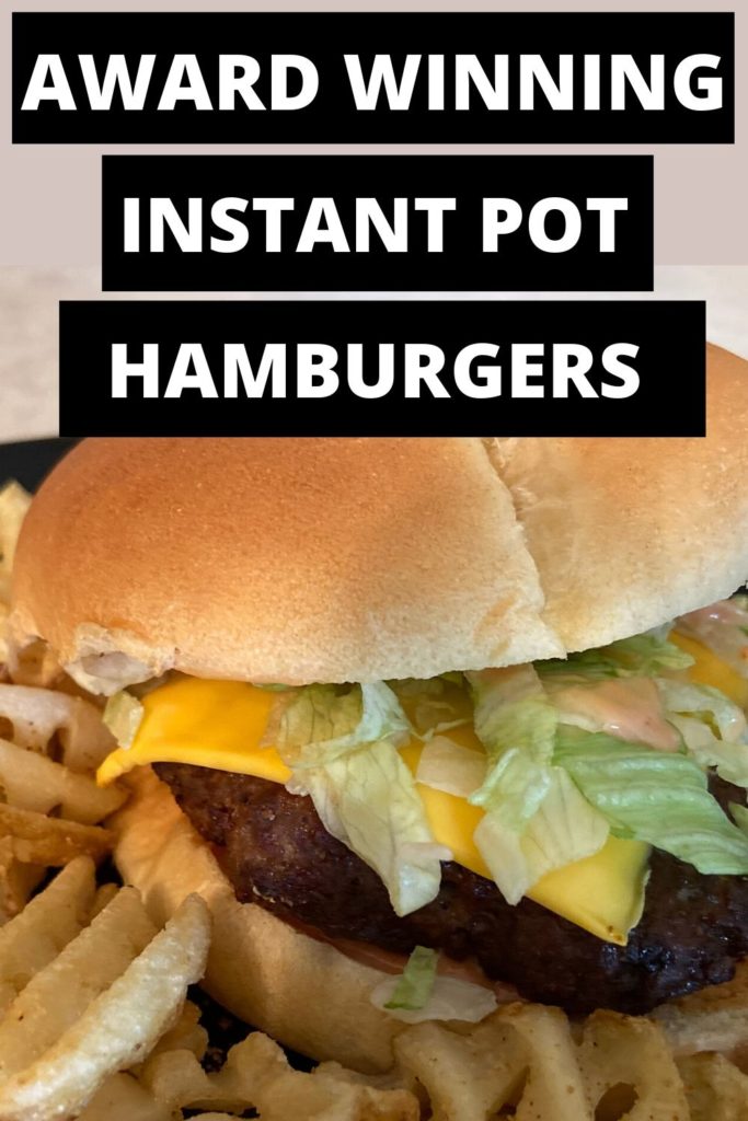 A instant pot cheeseburger and waffle fries on a black plate.