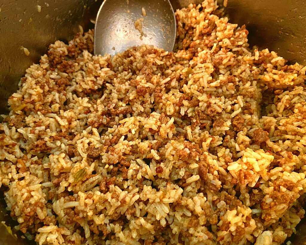 The inside of an Instant Pot filled with Instant pot ground beef and rice.