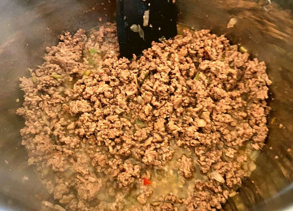 Ground beef browning inside of an Instant Pot.