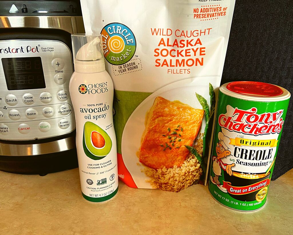 Instant Pot, Spray Avocado Oil, Bag of frozen Salmon Fillets, and Tony Chachere's Seasoning. (Ingredients - Instant Pot Duo Crisp Salmon Fillets