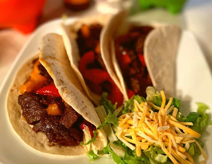 Instant Pot Steak Fajitas with red, yellow, and orange bell peppers.