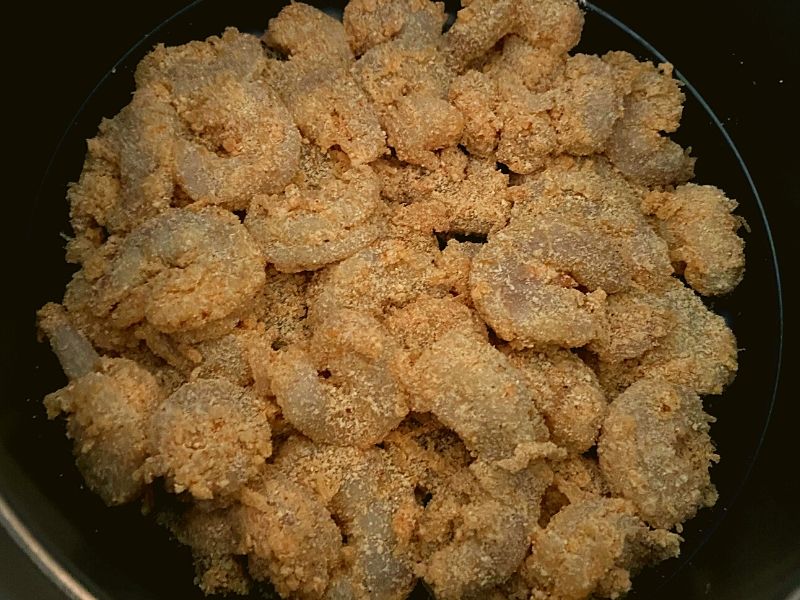 Raw shrimp breaded in a Instant Pot Duo Crisp about to be air fried.