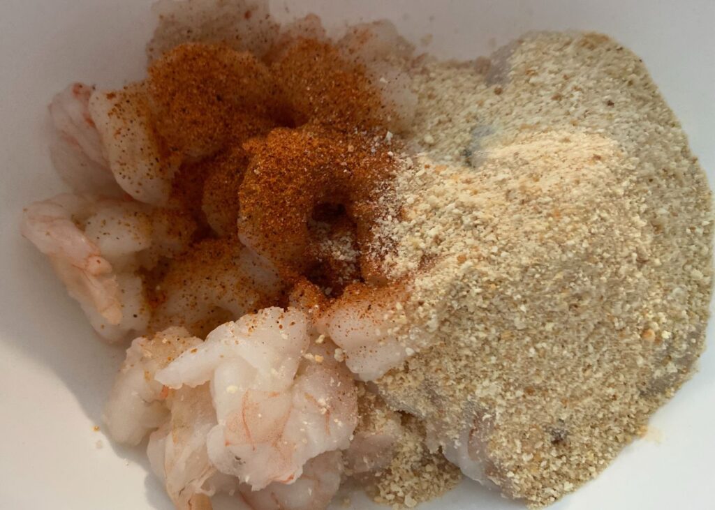 Raw Shrimp being seasoned to cook in the instant pot