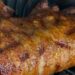 A cooked pork tenderloin resting on a ninja foodi grill
